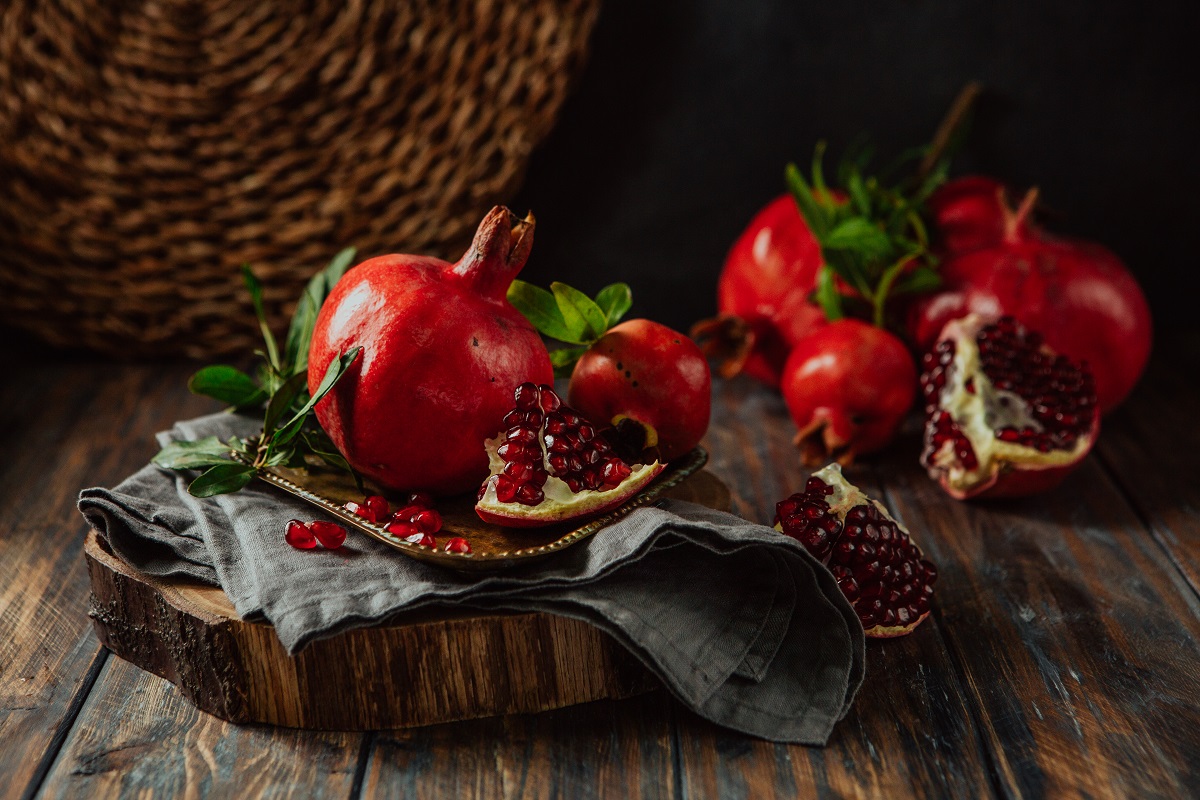 Beautiful,Red,Pomegranate,Fruit,Composition,On,A,Wooden,Background.,Azerbaijan