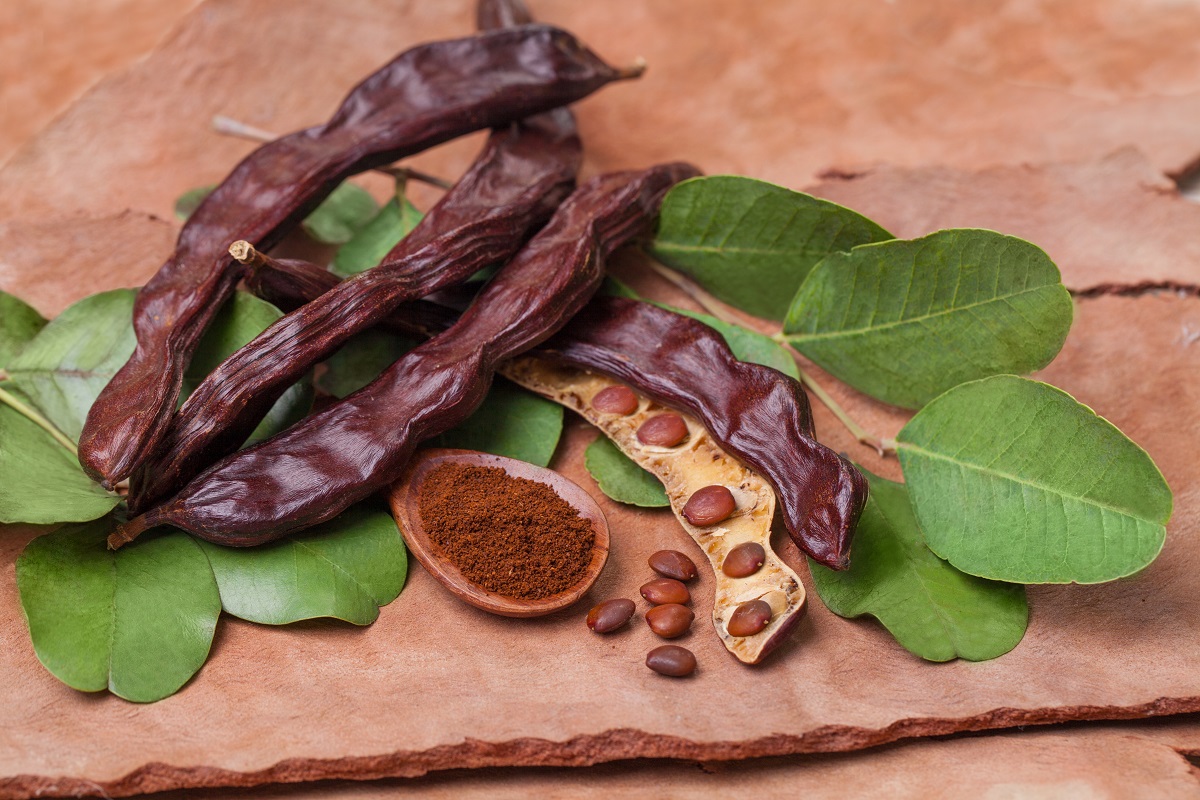 Carob.,Organic,Carob,Pods,With,Seeds,And,Leaves,On,Tree