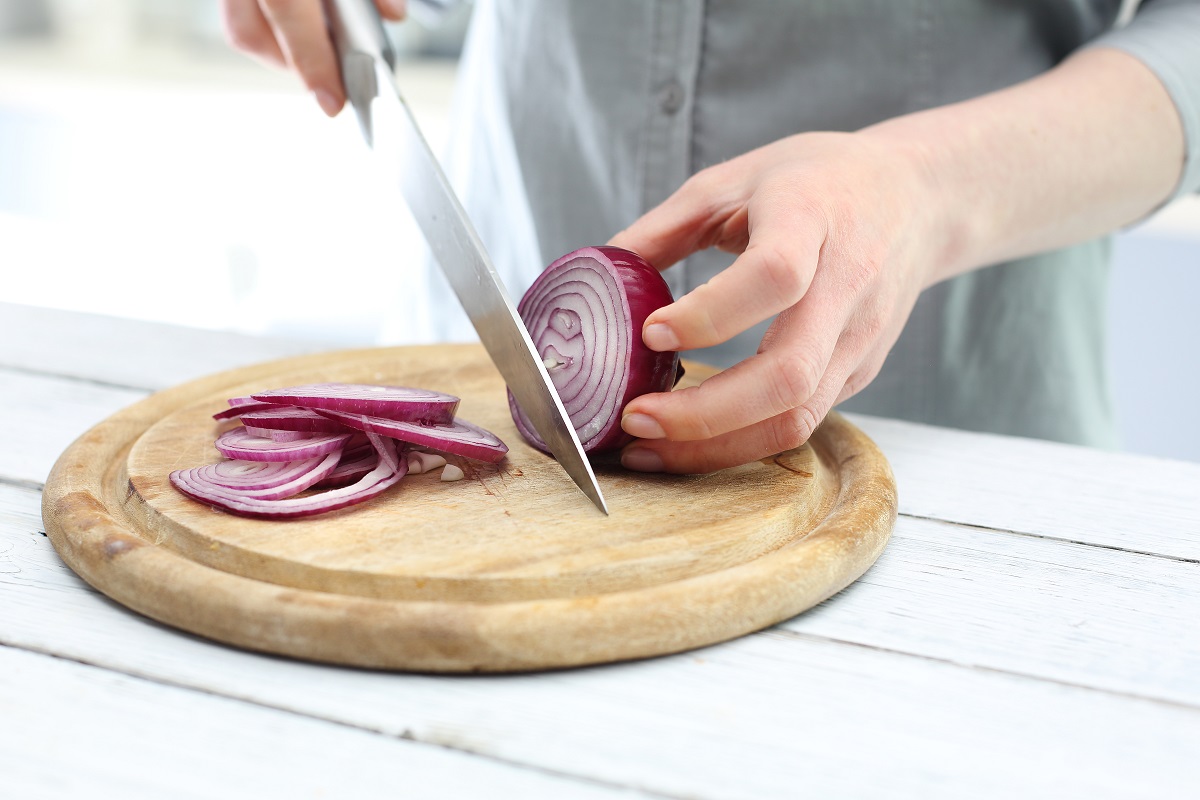 Cutting,The,Onion,Into,Slices.,Woman,Cut,Red,Onion