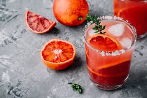Blood,Orange,Sangria,With,Ice,And,Thyme,On,Dark,Backgorund