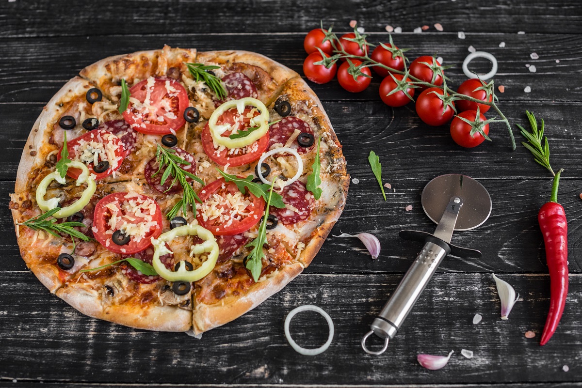 Vegetables,,Mushrooms,And,Tomatoes,Pizza,On,A,Black,Wooden,Background.