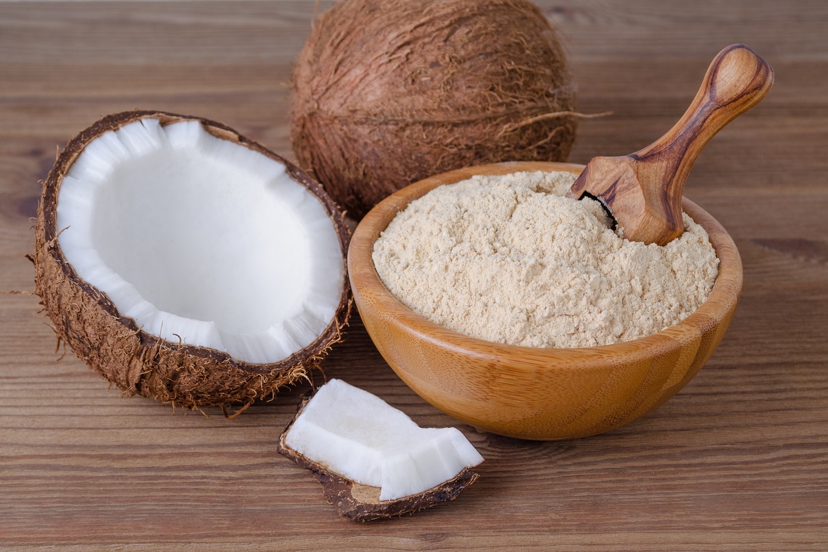 Coconut,Flour,In,A,Bowl,With,Scoop,On,Brown,Wooden