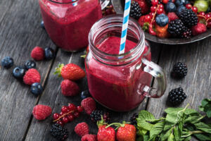 Summer,Berries,Smoothie,In,Mason,Jar,On,Rustic,Wooden,Table