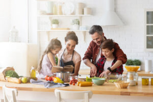 Happy,Family,Cooking,Together,On,Kitchen.,Mother,And,Daughter,Reading