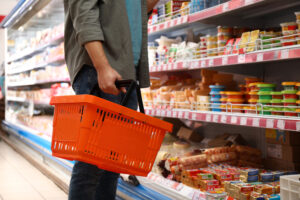 Man,With,Shopping,Basket,In,Supermarket,,Closeup