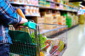 Man,Pushing,Shopping,Cart,Full,Of,Food,In,The,Supermarket