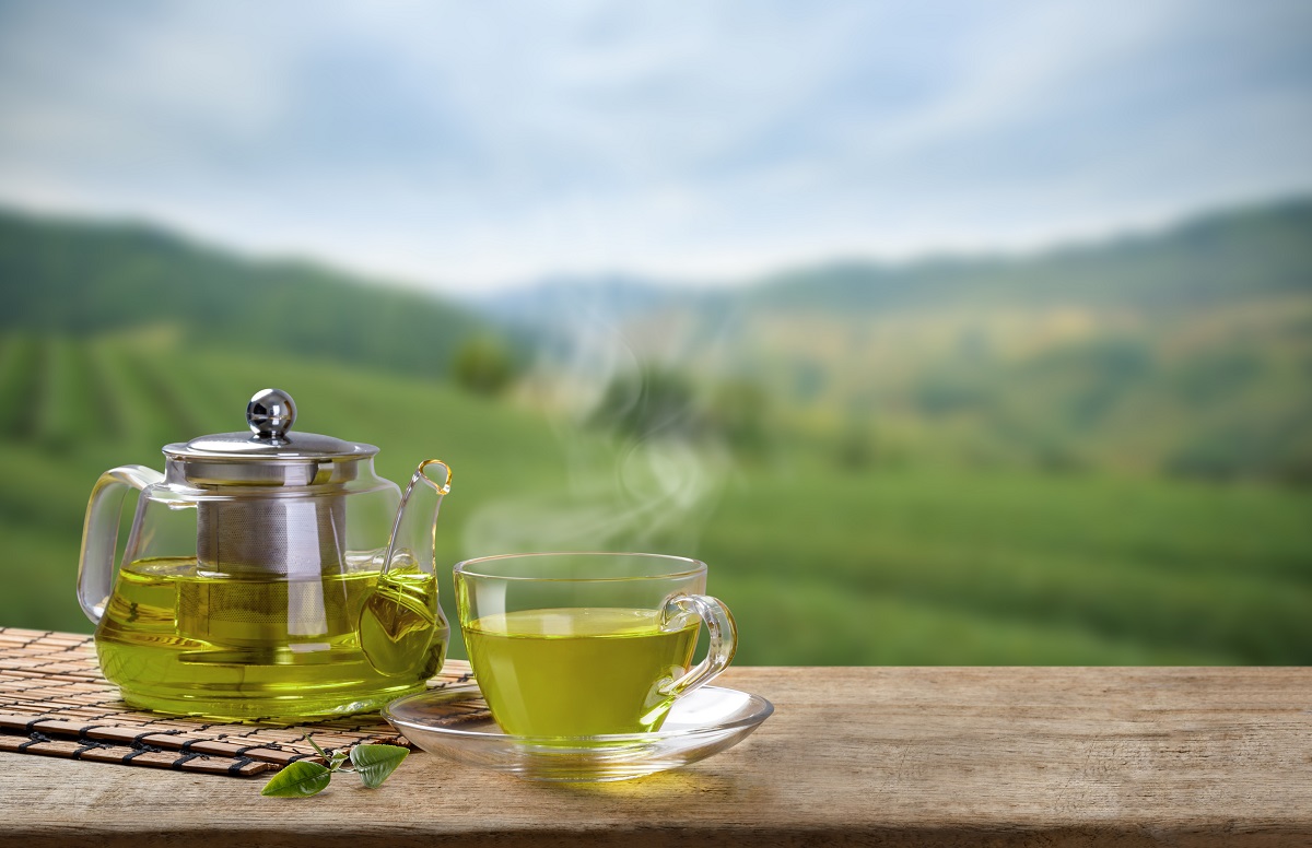 Warm,Cup,Of,Green,Tea,And,Glass,Jars,With,Leaf