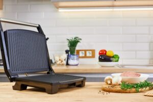Electric,Grill,With,Meat,And,Spices,On,Cutting,Board.,Electric
