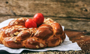 Easter,Traditional,Bread,,Greek,Tsoureki,And,Red,Eggs,On,A