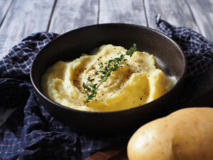 Mashed,Potato,Topped,With,Thyme,Branches,And,Pepper,In,Dark