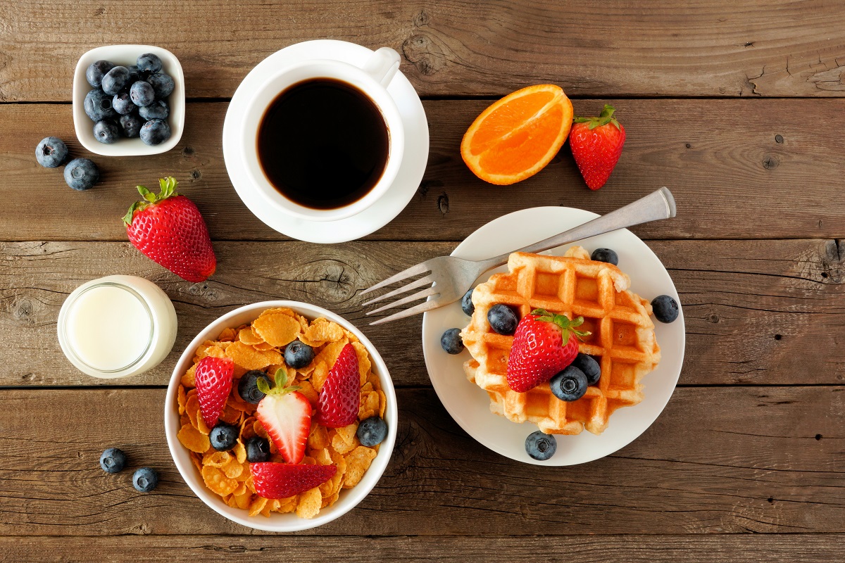 Breakfast,Food,Table,Scene.,Fruits,,Cereal,,Waffles,,Milk,And,Coffee.