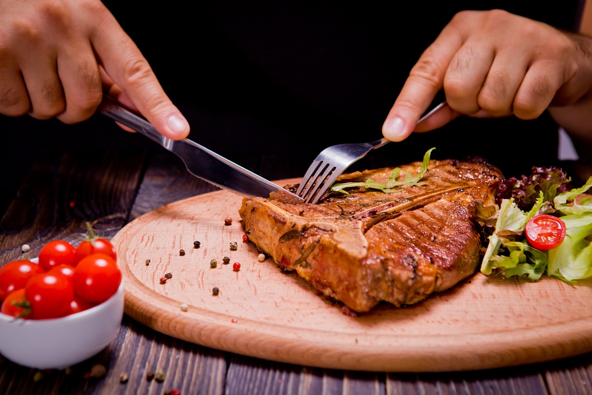 Eating,Stake,From,Plate,With,Fork,And,Knife,Man,Hands
