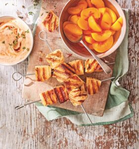 Grilled halloumi,pickled peach andchipotle-thymeyogurt kebabs, skewers