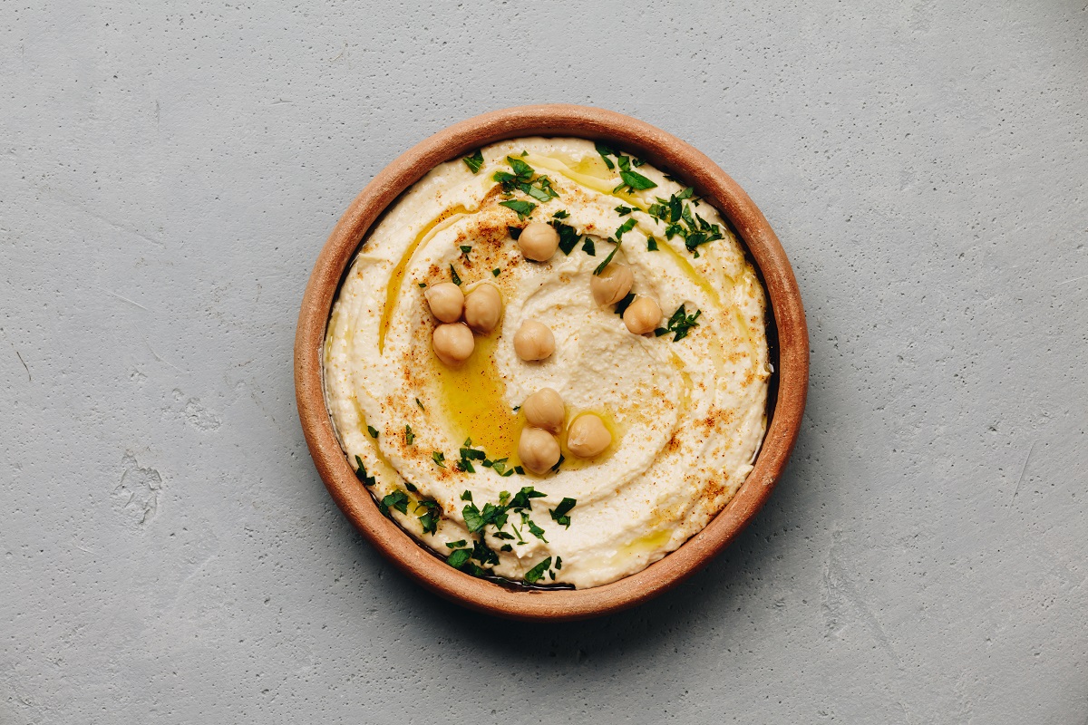 Hummus.,Large,Bowl,Of,Homemade,Hummus,Garnished,With,Chickpeas,,Red