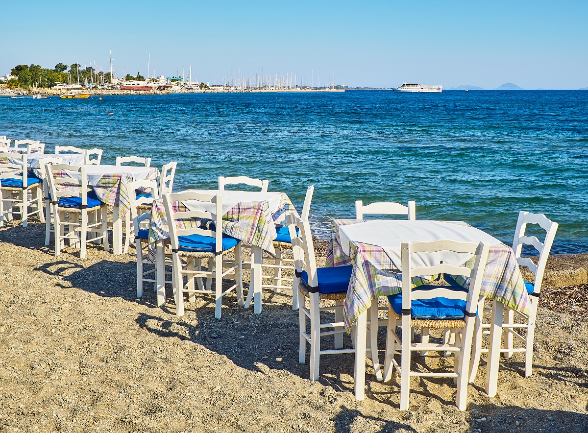 Tables,With,Chairs,Of,A,Greek,Tavern,Near,The,Sea