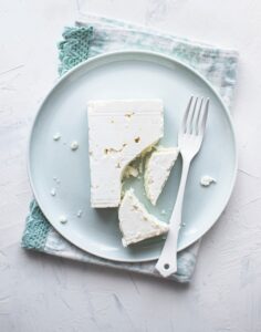 Feta,Cheese,On,A,White,Plate,With,Fork,Flat,Lay