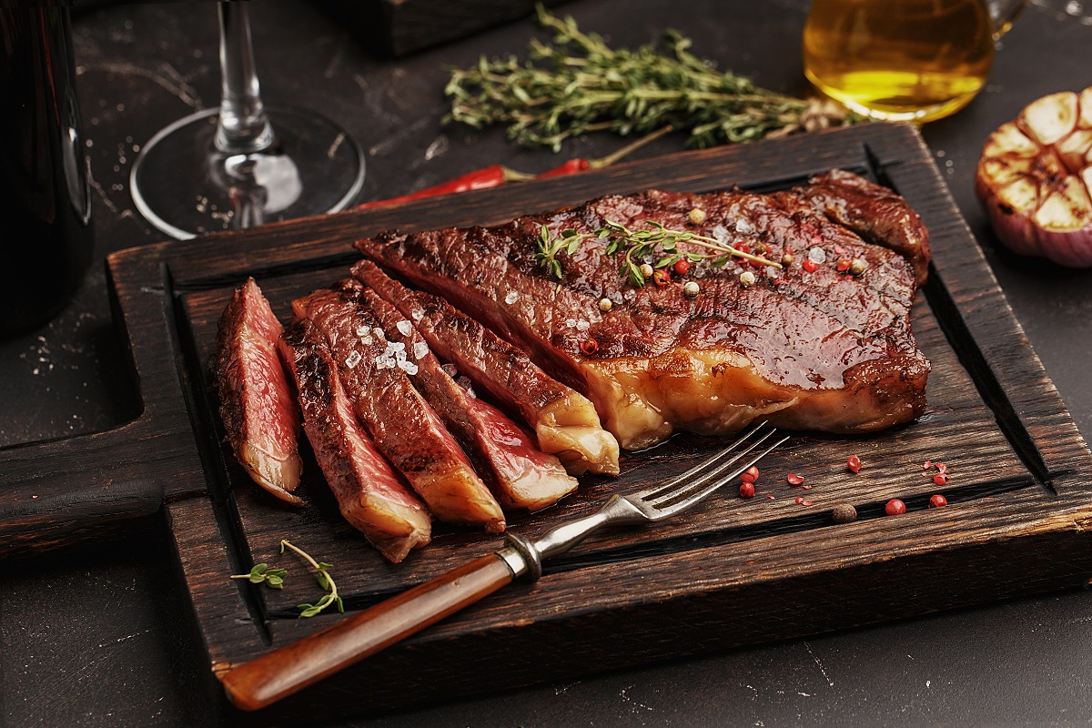 Medium,Rare,Sliced,Grilled,Striploin,Beef,Steak,Served,On,Wooden