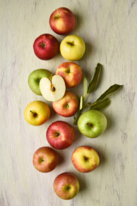 A,Group,Of,Different,Varieties,Of,Apples,With,Leaves,On