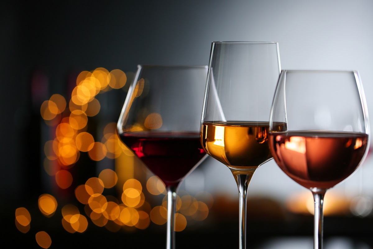 Glasses,With,Different,Wines,Against,Defocused,Lights,,Closeup.,Space,For