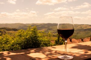 Glass,Of,Red,Wine,On,The,Hills,Of,Tuscany,In