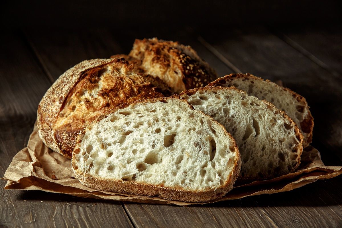 Bread,,Traditional,Sourdough,Bread,Cut,Into,Slices,On,A,Rustic