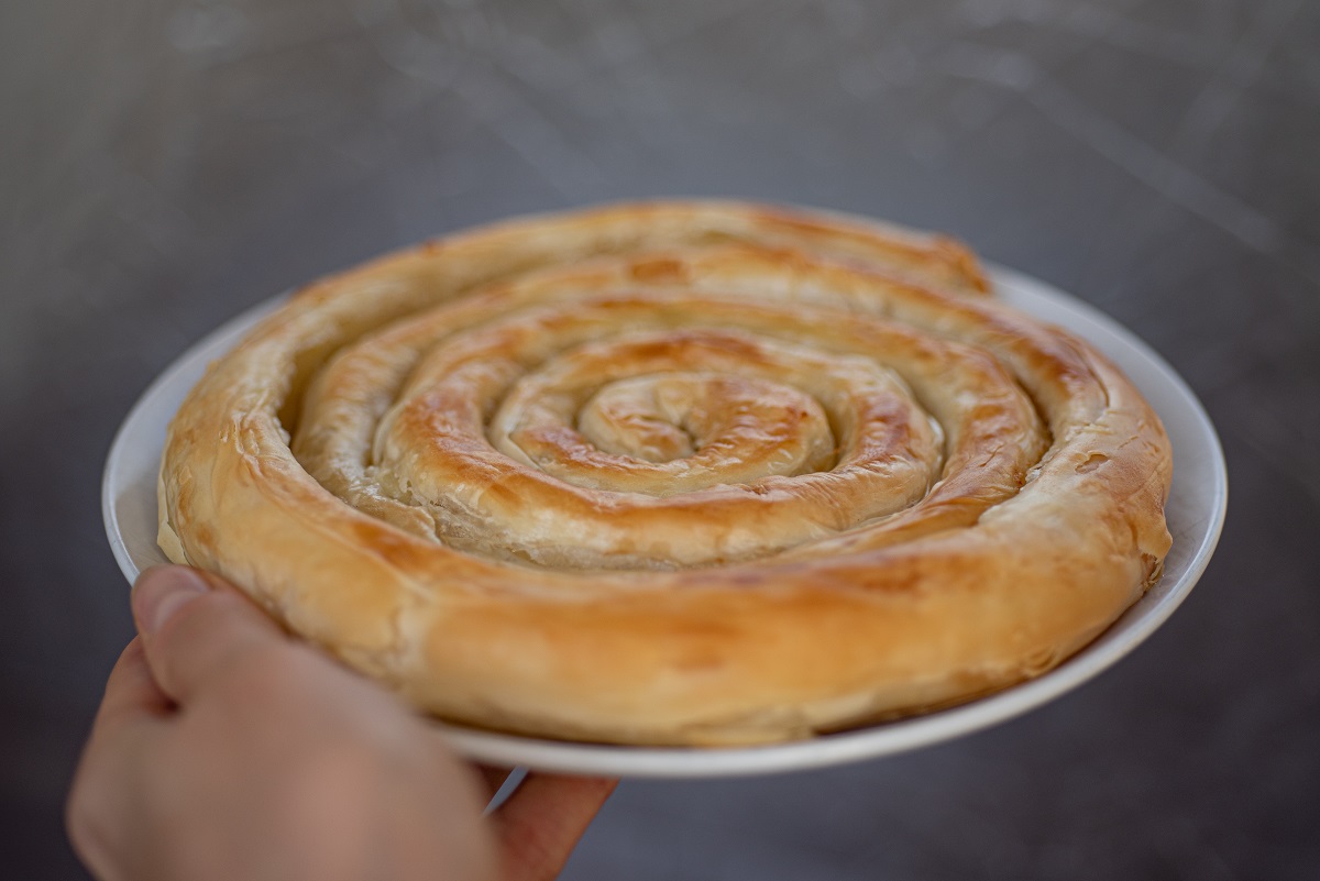 Spiral-shaped,Greek,Cheese,Pie,(kichi,Kozanis),In,Female,Hand,On